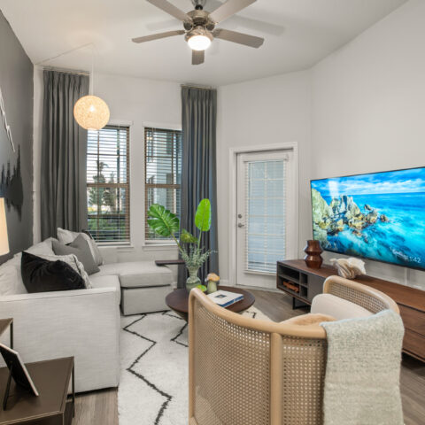 living room with sofa, accent chair, and tv at Sanctuary at Daytona
