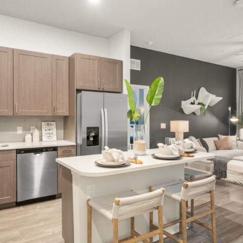living room and kitchen with island and stainless steel appliances at Sanctuary at Daytona