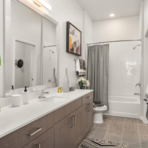 bathroom with tub and shower with full vanity and storage at Sanctuary at Daytona