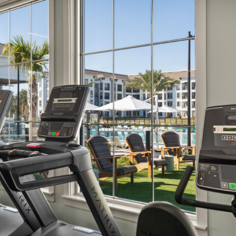 treadmills and workout bike overlooking the pool at Sanctuary at Daytona