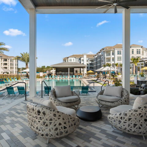 covered outdoor lounge seating by the pool at Sanctuary at Daytona