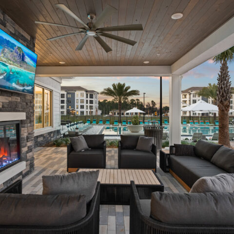 Outdoor lounge area with TV and fireplace at Sanctuary at Daytona