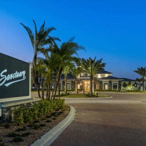 exterior welcome sign leading to the parking and the clubhouse at Sanctuary at Daytona